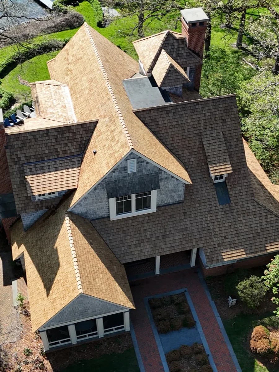 Aerial view of a cedar-shake roof replacement on a Minnesota home